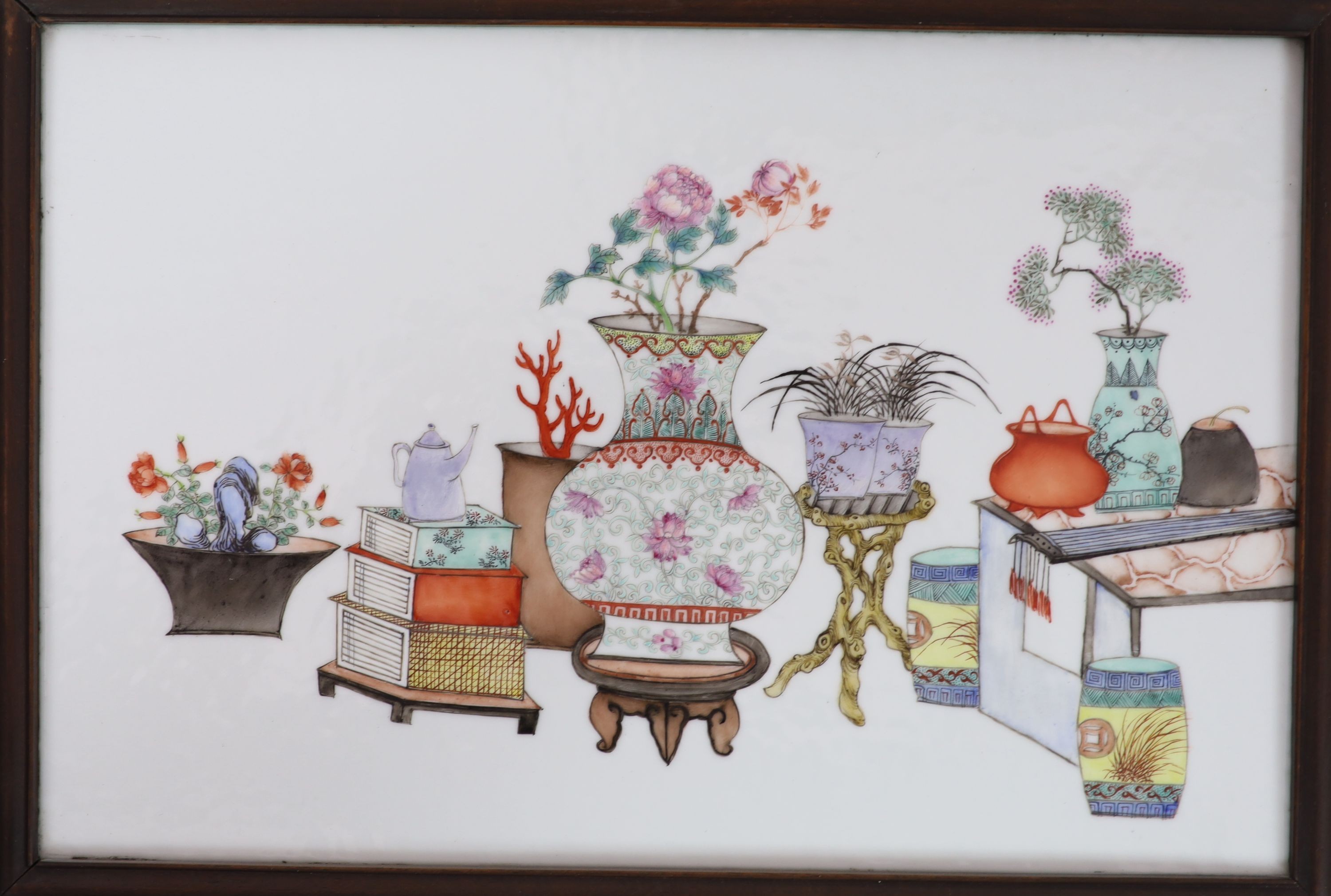 A set of four Chinese famille rose 'Hundred Antiques' plaques, late Qing dynasty, porcelain 26cm x 39cm, in hongmu and silk frames with jichimu insets to the back